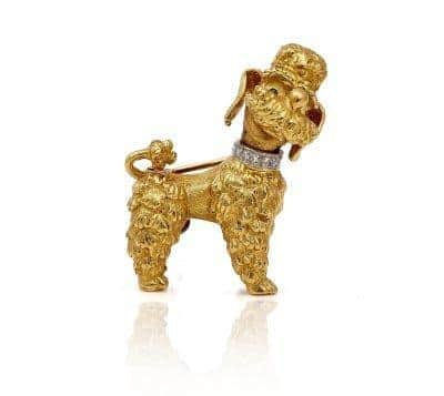 A 19ct gold brooch, designed as a standing poodle wearing a diamond set collar is set to be available at auction SUS-221101-135331001