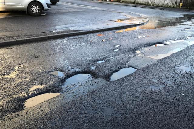 Potholes near the junction of Fairfield Road on Royal George Road, Burgess Hill. Picture: Mustak Miah.