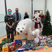 Representitives From Churchill Square and Rockinghorse take gifts to hospital with the help of Santa