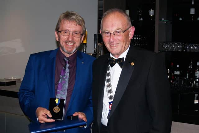 Chris received two Paul Harris Fellowship Awards. SUS-220118-095305001