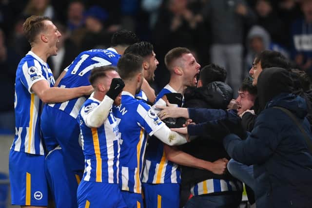 Adam Webster ran to celebrate with the fans after drawing Brighton level against Chelsea with a bullet header . (Photo by Mike Hewitt/Getty Images)