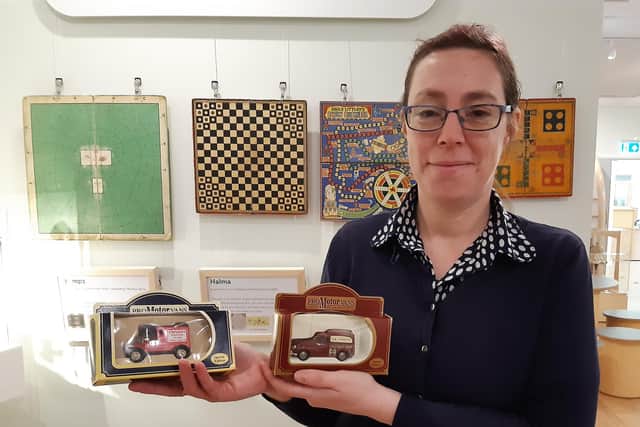Rustington Museum manager Claire Lucas with model cars featuring local businesses