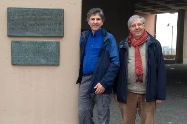 Tim (left) and his brother Stephen outside Dachau town hall, November 8, 2018. Standing by the memorial to Jews living in Dachau who were thrown out of town on November 8  1938.