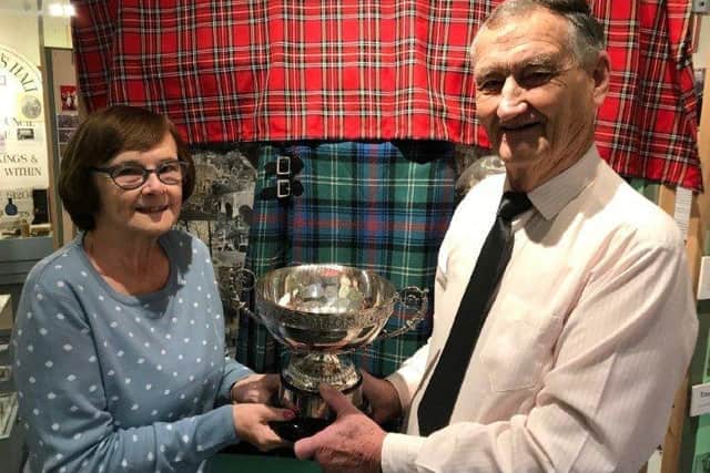 Long-standing Steyning resident Colin Gray presents the George Gray Rose Bowl to Steyning Museum chairman Muriel Wright