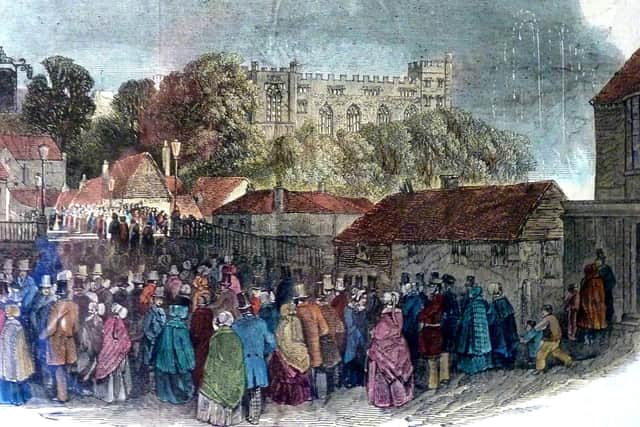 An illustrations showing Queen Victoria's royal visit in 1846, with people marvelling at the illuminated Arundel Castle and fireworks to celebrate