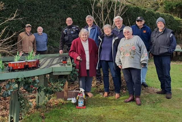 PCSO Daryl Holter with members of the East Sussex Garden Rail Group. Photo from Sussex Police. SUS-220102-125723001