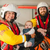 RNLI Brighton volunteer Emily Summerfield with fellow crew member Julian Cumberworth, who was the anaesthetist when baby William, also pictured, was born