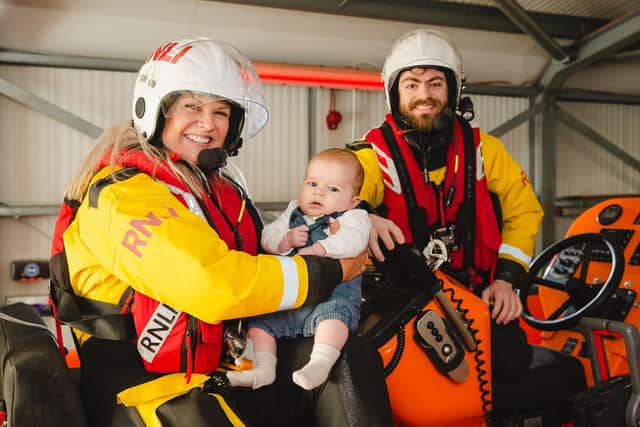 Baby William at the RNLI Brighton lifeboat station with mum Emily Summerfield and fellow crew member Julian Cumberworth