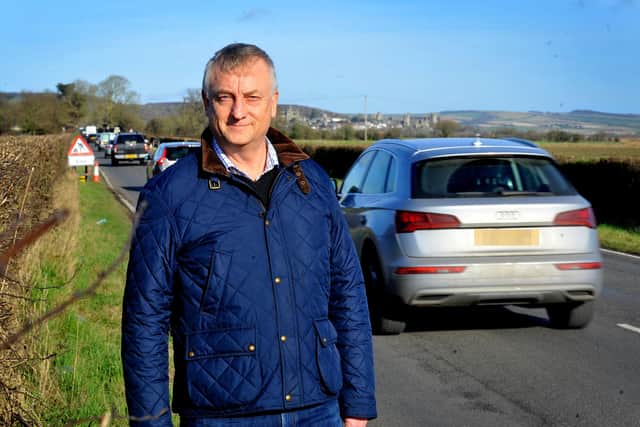 Andy Batty, pictured in Ford with Arudel in the distance, has been helping spearhead efforts to secure safe paths for cyclists and pedestrians between the two settlements. Pic by S Robards