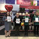 Alison Whitburn, community champion at Morrisons Littlehampton, right, with colleagues celebrating the total the store has raised for Young Lives vs Cancer since 2017