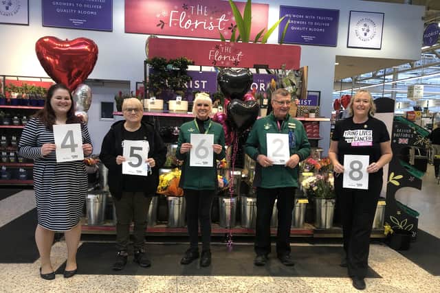 Alison Whitburn, community champion at Morrisons Littlehampton, right, with colleagues celebrating the total the store has raised for Young Lives vs Cancer since 2017