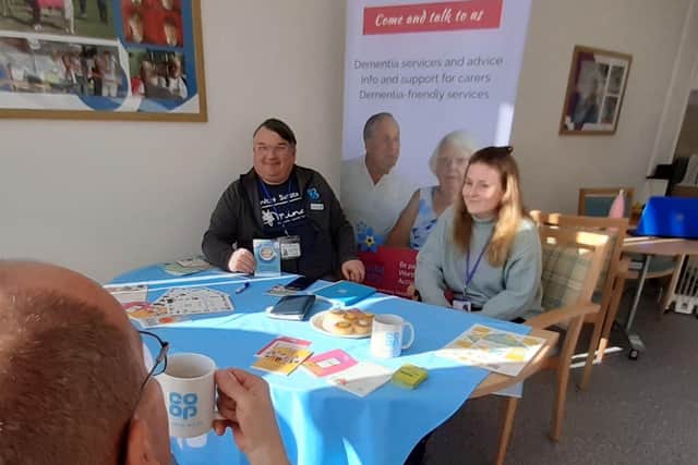Bob Smytherman, Co-op member pioneer for Worthing, chair of Wothing Dementia Action Alliance and trustee of West Sussex Mind, and Ella Divall, student social worker at Abbeyfield Ferring Society, chatting with a visitor on Time to Talk Day