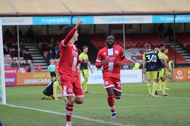 Tom Nichols celebrates one of his two goals against Stevenage with Remi Oteh in pursuit. Picture by Cory Pickford