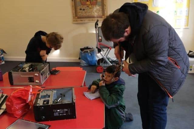 Children busy learning how to repair their computers. Picture: Haywards Heath Town Council.