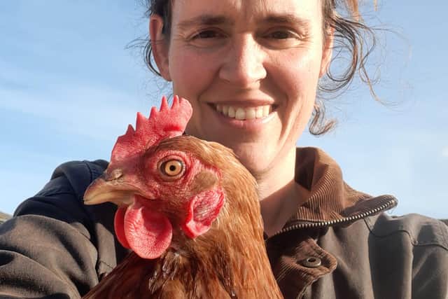 Sam Barter with one of her 50 chickens - the family have an array of animals as well as their flock of  sheep