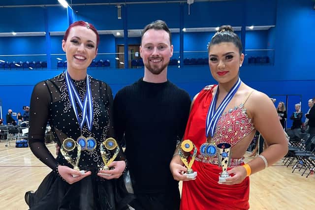 Zoe-Beth Hobbs, left, and Sienna Elman-Baker with Jake Hooker, principal of Hove Dance Centre, at the Imperial Society of Teachers of Dance qualifying competition in Fleet