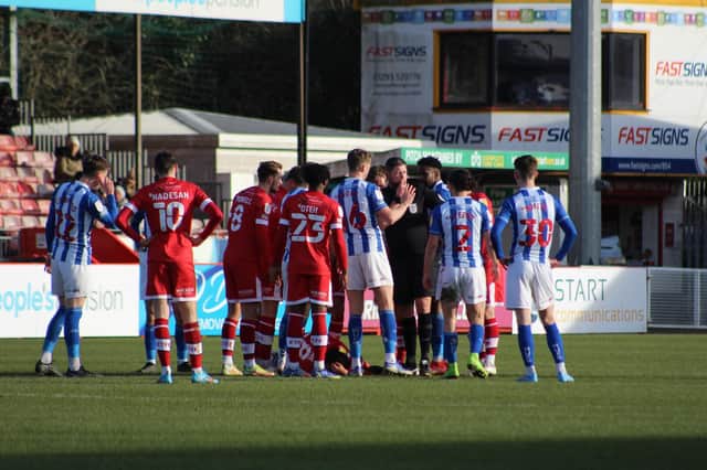 Players surround the referee after Omar Bogle's challenge on Jack Payne. Picture by Cory Pickford