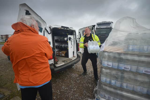 South East Water handing out bottles of water to residents outside Bexhill Sea Angling Club after Storm Eunice caused a lack of power to water pumping stations. SUS-220222-122938001