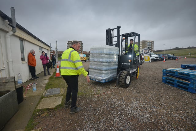 South East Water handing out bottles of water to residents outside Bexhill Sea Angling Club after Storm Eunice caused a lack of power to water pumping stations. SUS-220222-122901001