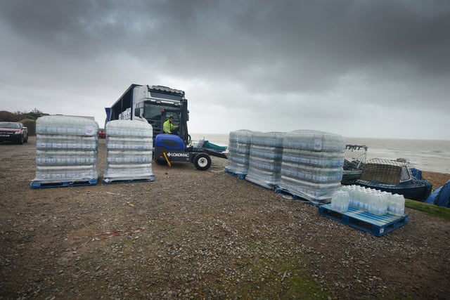 South East Water handing out bottles of water to residents outside Bexhill Sea Angling Club after Storm Eunice caused a lack of power to water pumping stations. SUS-220222-123044001