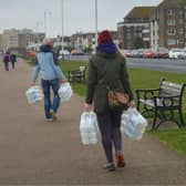 South East Water handing out bottles of water to residents outside Bexhill Sea Angling Club after Storm Eunice caused a lack of power to water pumping stations. SUS-220222-123058001