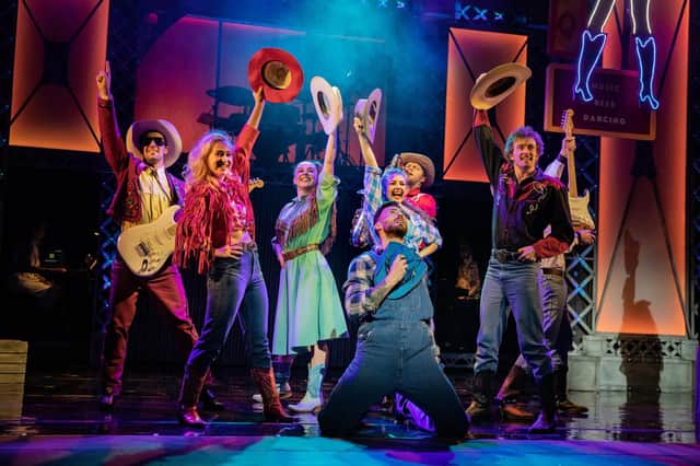 Jake Quickenden (front) on stage at the Theatre Royal Brighton with other cast members from Footloose The Musical