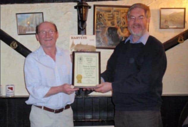 David Sansbury, left, being presented with a CAMRA certificate by CAMRA representative Peter Page-Mitchell SUS-220224-104949001
