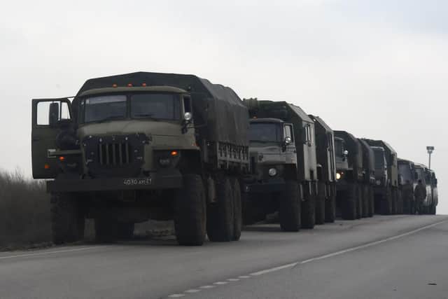 Russian military trucks and buses are seen on the side of a road in Russia's southern Rostov region, which borders the self-proclaimed Donetsk People's Republic. (Photo by STRINGER / AFP) (Photo by STRINGER/AFP via Getty Images) SUS-220224-111547003