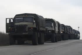 Russian military trucks and buses are seen on the side of a road in Russia's southern Rostov region, which borders the self-proclaimed Donetsk People's Republic, on February 23, 2022. (Photo by STRINGER / AFP) (Photo by STRINGER/AFP via Getty Images) SUS-220224-111547003