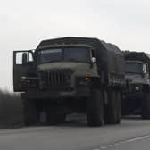 Russian military trucks and buses are seen on the side of a road in Russia's southern Rostov region, which borders the self-proclaimed Donetsk People's Republic, on February 23, 2022. 
(Photo by STRINGER/AFP via Getty Images)