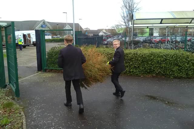 The Regis School’s Rights Respecting Ambassadors helped load and sort trees ready to be taken to be composted as part of the St Wilfrid's Hospice's scheme