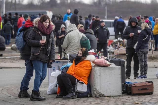 Ukrainian citizens are seen arriving at the Medyka pedestrian border crossing fleeing the conflict in their country, in eastern Poland on February 27, 2022. - As Ukraine braces for a feared Russian invasion, its EU member neighbours are making preparations for a possible influx of hundreds of thousands or even millions of refugees fleeing military action. (Photo by Wojtek RADWANSKI / AFP) (Photo by WOJTEK RADWANSKI/AFP via Getty Images)