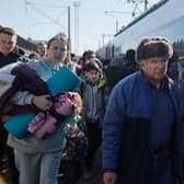 KYIV, UKRAINE - FEBRUARY 28: Local residents rush to catch a train evacuating the population to the western regions of Ukraine on February 28, 2022 in Kyiv, Ukraine. As Russia's large-scale invasion of Ukraine entered its fifth day, the capital was quieter overnight but Russian forces continued to mass outside the city. Ukrainian forces waged battle to hold other major cities. (Photo by Pierre Crom/Getty Images)