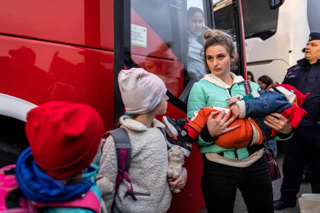 Refugees arrive with buses from the Medyka pedestrian border crossing, in Przemsyl, eastern Poland (Photo by Wojtek RADWANSKI / AFP) (Photo by WOJTEK RADWANSKI/AFP via Getty Images) NNL-220103-173616001