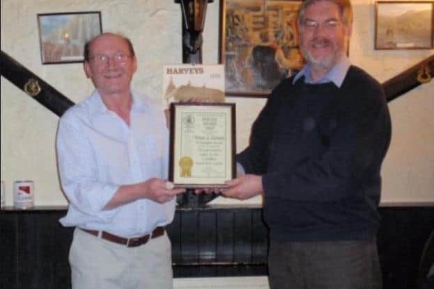 David Sansbury, left, being presented with a CAMRA award by Peter Page-Mitchell SUS-220603-141855001