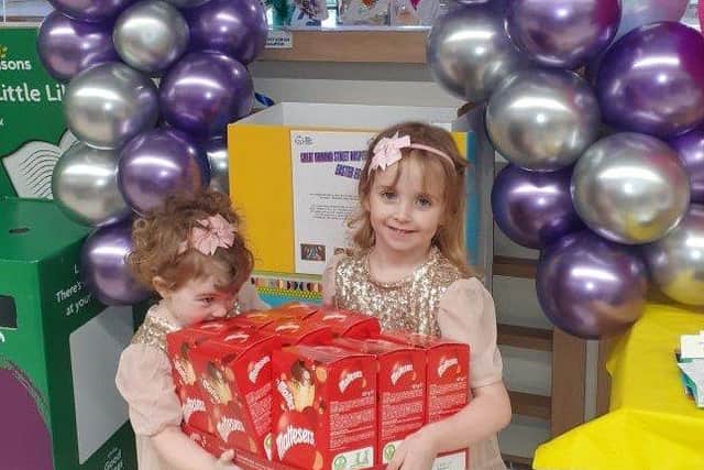 Annabelle Tierney and her sister Florence at Morrisons in Worthing with some of the Easter eggs