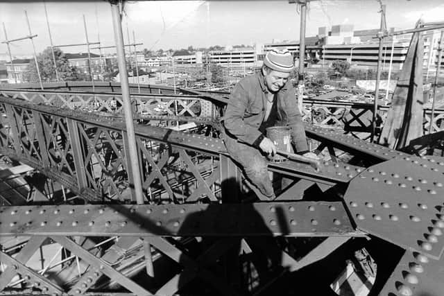 An engineer at work during a 1983 repainting of Crescent Bridge.