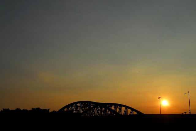 The stark silhouette of Crescent Bridge stands out against a summer evenings' sunset.