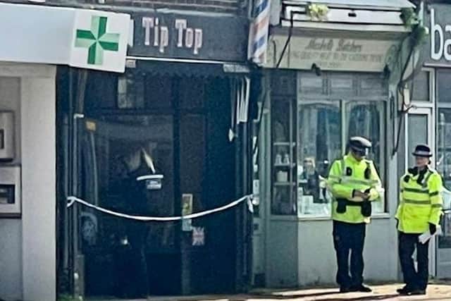 Police officers standing outside Tip Top barbers in Broadwater Street West