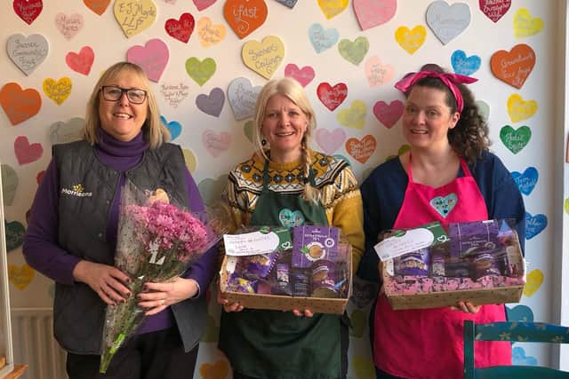 Alison Whitburn, community champion at Morrisons Littlehampton, presents hampers to Claire Jones and Felicity Jay at Creative Heart to celebrate International Women's Day