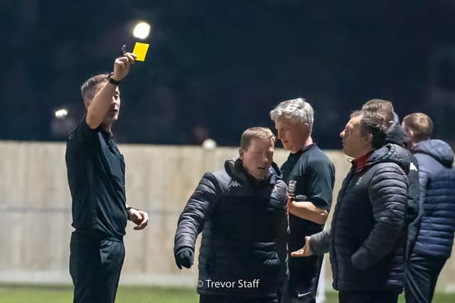 The ref shows a yellow card to a member of the Bognor staff in the confusion over the Casuals player coming back on / Picture: Trevor Staff