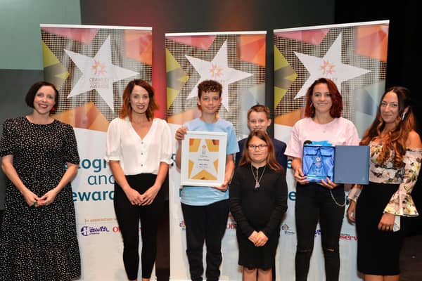 Super Siblings accepting the Charity of the Year award from Community Awards Judge Katie Bennett in 2021