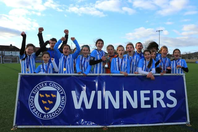 Worthing United U12 Girls lift the cup / Picture: Simon Roe Photography