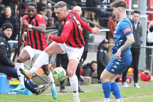 Lewes' Joe Taylor in the thick of the action against Worthing / Picture: Angela Brinkhurst