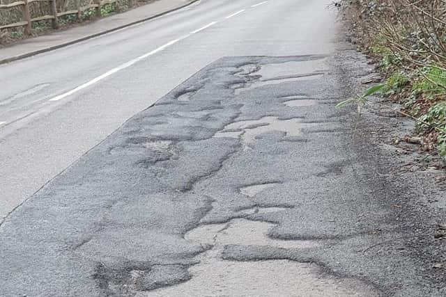 Potholed road at Gillsmans Hill, St Leonards. SUS-221003-150149001