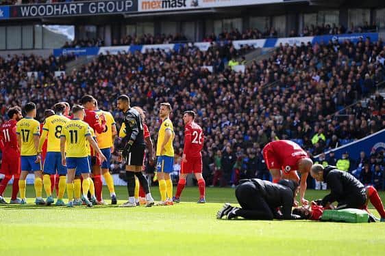 Liverpool striker Luis Diaz receives treatment after he was crudely taken out by Brighton goalkeeper Rob Sanchez