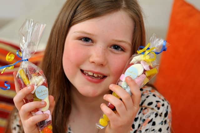 Rebecca Newman, 8, has been making cones full of sweets to sell and raise money for Ukraine. Pic S Robards SR2203142 SUS-220314-171230001