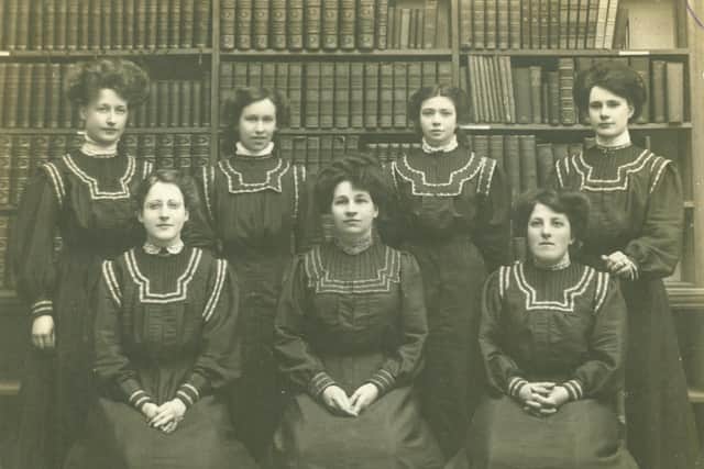Staff in Worthing Library before the First World War, posing in front of the bookshelves in their winter overalls, including deputy librarian, later librarian, Ethel Gerard, standing far left, and librarian Marian Frost, seated, centre. Seated at the right is possibly Miss Paine and standing at far right is possibly Dorothy Moss. Picture West Sussex County Council Library Service www.westsussexpast.org.uk