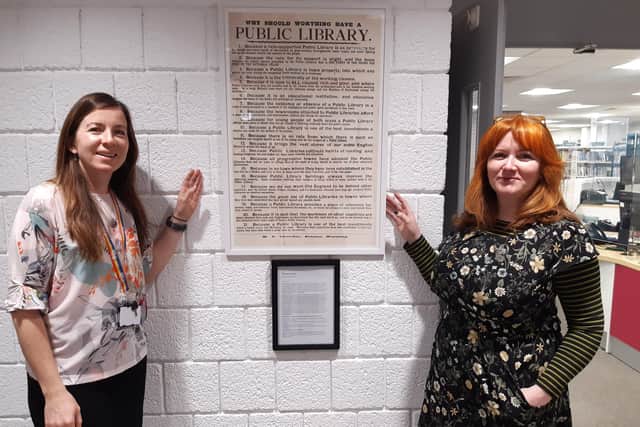 Librarian Amy Perry, left, and Dr Annebella Pollen with the poster giving 21 reasons why Worthing should have a public library