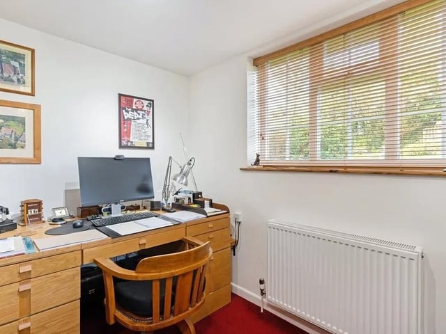 The study is set from the rest of the accommodation and fitted with bespoke oak bookshelves. Picture: Savills - Haywards Heath.